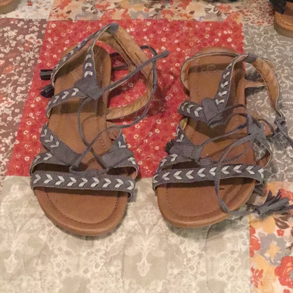 Gray lace up sandals.